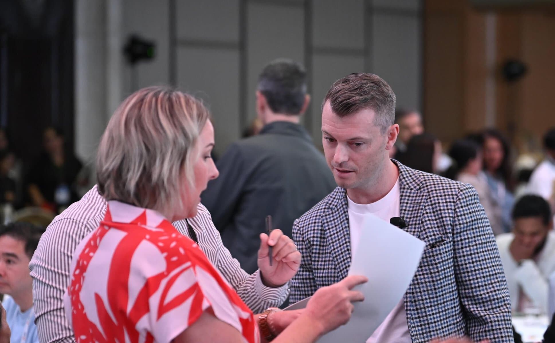 Two professionals engaging in a leadership discussion at a workshop.